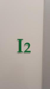 un cartel con el número en una pared en Pagani Green - Luxury Maisonette I2, en Kalamata