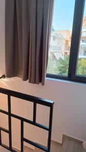 a bedroom with a bed and a window at Pagani Green - Luxury Maisonette I2 in Kalamata