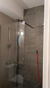 a bathroom with a shower with a glass door at Pagani Green - Luxury Maisonette I2 in Kalamata