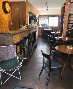 a restaurant with tables and chairs and a bar at GUEST HOUSE NAGORIYA in Hikone +14 photos