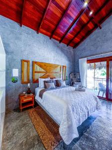 a bedroom with a large bed and a large window at Pousada Luna - D3 Experience - Preá, CE in Prea