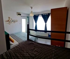 a bedroom with a bed and a large window at MBI Smart Central in Craiova