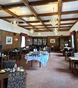 a dining room with tables and chairs and chandeliers at The Royal Lion Hotel in Lyme Regis