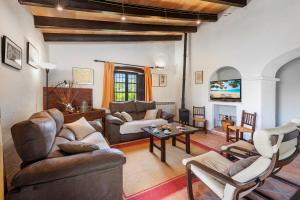 a living room with a couch and a table at Coster Puig in Pollença