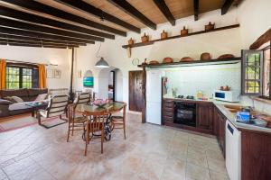 a kitchen and living room with a table and chairs at Coster Puig in Pollença