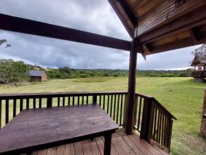 a wooden porch with a wooden bench on a deck at Kragga Kamma Game Park in Port Elizabeth