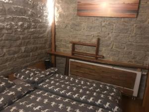 a bedroom with a bed and a stone wall at T's Apartment in Tallinn