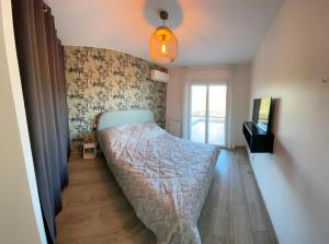 a bedroom with a bed in a room with a window at Boost Your Immo Corse Solenzara Tozza Alta 819 in Le Pont du Travo
