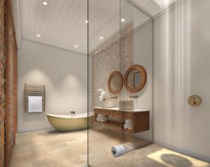 een badkamer met een bad en een wastafel bij La Petite Ferme in Franschhoek