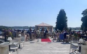 a group of people sitting in chairs at a ceremony at St Kyrans Guest House in Virginia