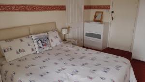 a bedroom with a large bed with pillows at The Kathrene Second Floor Sea View in Fleetwood