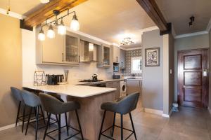 a kitchen with a island with bar stools at La Pirogue 14 in Ballito