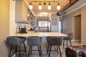 a kitchen with a large island with chairs around it at La Pirogue 14 in Ballito