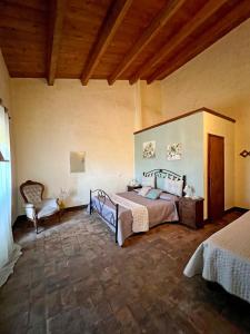 1 dormitorio grande con 1 cama y 1 silla en Palatium Le Caselle, en Viterbo