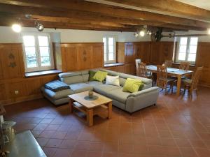 a living room with a couch and a table at Ferienhaus Alte Wagnerei Steinatal - Ühlingen-Birkendorf in Ühlingen-Birkendorf