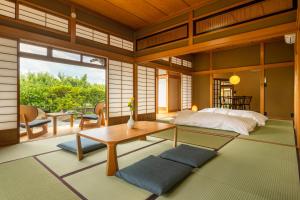 - une chambre avec un lit et une table dans l'établissement Temple Hotel 南アルプス法源寺, à Minami Alps