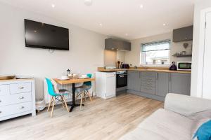 a kitchen with a table and a kitchen with a dining room at Annabelle's Den in Gatehouse of Fleet