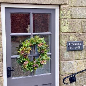a door with a window with a wreath on it at Grove House Levisham in Pickering