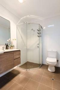 a bathroom with a toilet and a glass shower at Salt & Pepper; Beautiful Town House in Margs! in Margaret River Town
