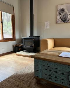 a living room with a stove and a couch at Noble River Estate in Dwellingup