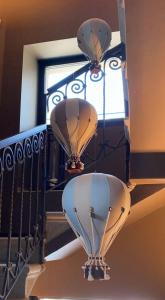 two hot air balloons hanging from a balcony at DIMORA1934 Relax&Comfort in Tirano