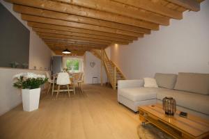 a living room with a couch and a table at CreamHouse in Międzyzdroje