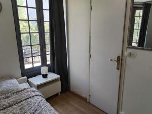 a bedroom with a bed and a window at Studio Saint-Jacques in Paris