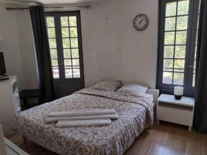 a bedroom with a bed with two towels on it at Studio Saint-Jacques in Paris