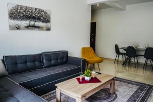 a living room with a couch and a table at Silver Central Apartment in Volos
