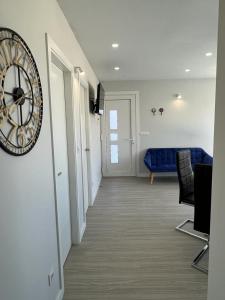 a living room with a clock on the wall at PASEO MARÍTIMO PANXON in Nigrán +15 photos