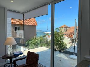 a room with a view of the ocean from a house at PASEO MARÍTIMO PANXON in Nigrán