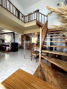 a living room with a wooden staircase in a house at Our Home in Heraklio +34 photos