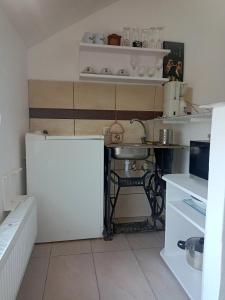 a small kitchen with a sink and a table at Arad Apartment - Cozy Vintage new in Arad