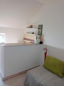 a white kitchen with a green chair in a room at Arad Apartment - Cozy Vintage new in Arad