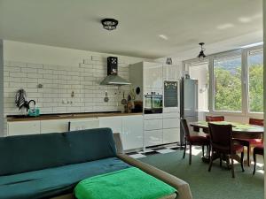 a living room with a couch and a table with chairs at TETA NEDA in Omiš