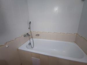 a white bath tub in a small bathroom at Комплекс Виста Дел Мар 2, студио in Sunny Beach