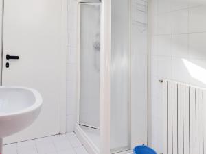 a white bathroom with a sink and a shower at Homiday - BordoPineta Centro in Pineto +39 photos