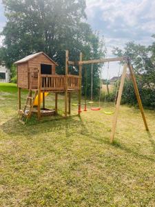 um parque infantil com escorrega e um baloiço em Logement B / Clos des Saunières em Bligny-lès-Beaune