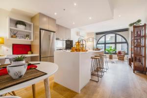 a kitchen with a white counter and a table at Charming 1-Bedroom Heritage Apartment in Melbourne