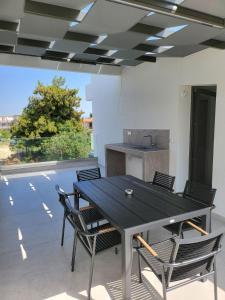 a table and chairs in a room with a kitchen at Evion Residence A11 in Nikiti