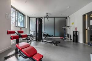 a gym with cardio equipment in a room at Charming 1-Bedroom Heritage Apartment in Melbourne
