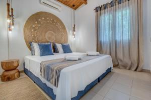 a bedroom with a large bed and a large window at Corfu Glyfada Sea blue 137 in Glyfada