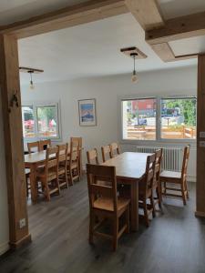 a dining room with wooden tables and chairs at Chalet Jaune Le GRAND SOM in Sarcenas