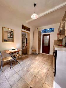 a kitchen and dining room with a table and a tableablish at Brezza Marina in Scilla +15 photos