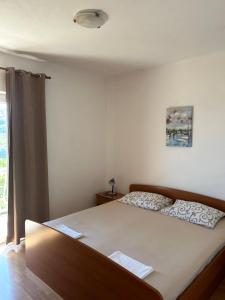 Postel nebo postele na pokoji v ubytování Apartments Antunović