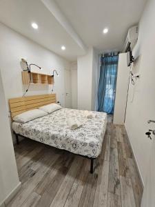 a bedroom with a bed and a wooden floor at Kos in Florence