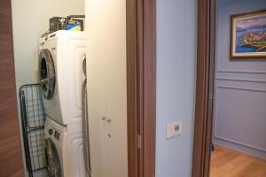 a washer and dryer in a room next to a door at Casa Hemingway - WelcHome in Stresa