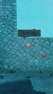 a street sign that reads pizza mudt on a stone wall at SebRem in Megève