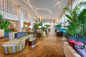a lobby with couches and potted plants at Akra Hotel in Antalya