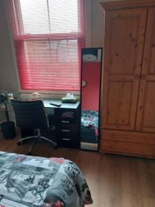 a bedroom with a bed and a desk and a window at White Hart Lane walking distance Tottenham Hotspur Stadium in London